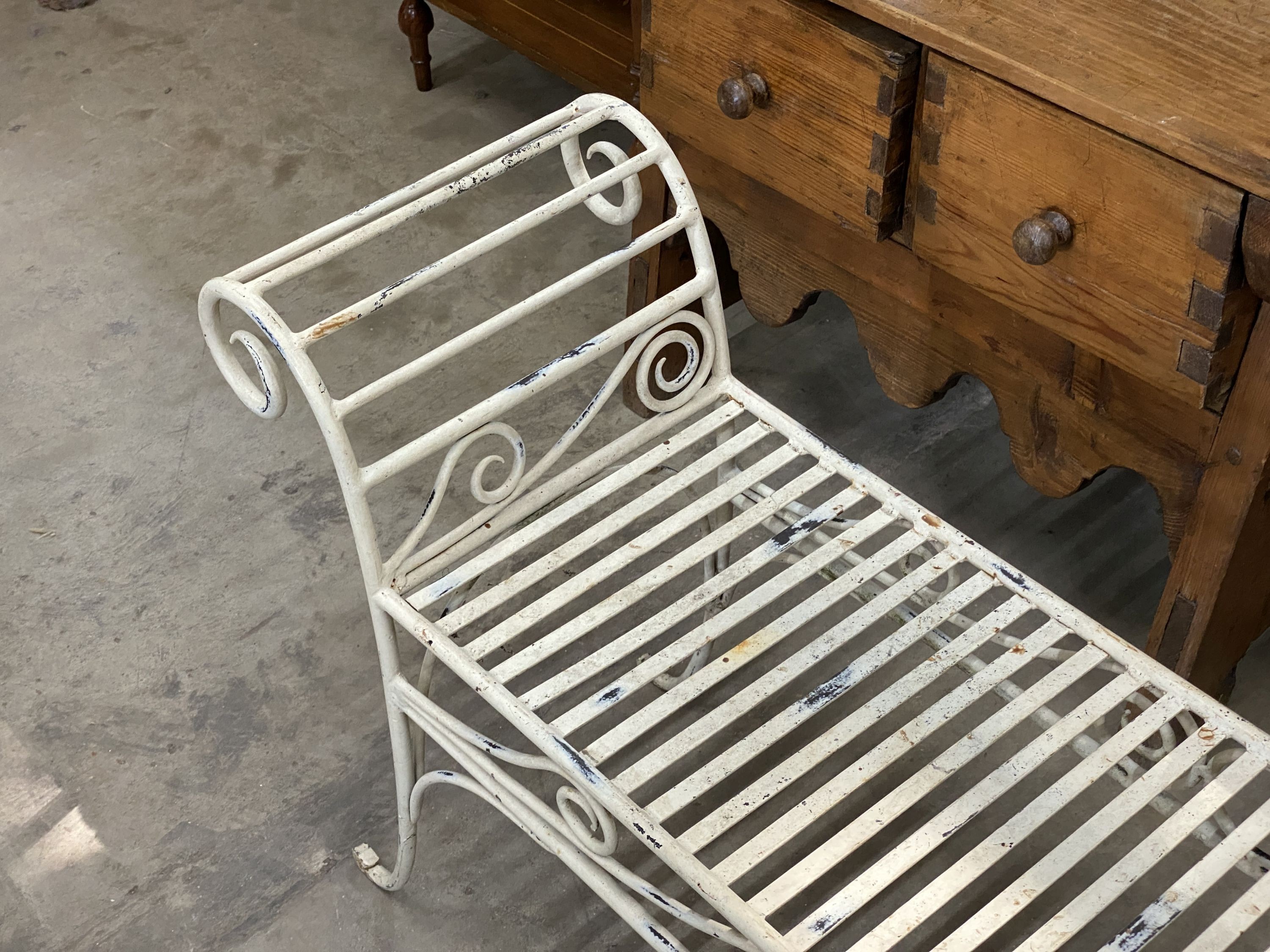 A painted wrought iron scroll end garden bench, length 130cm, depth 34cm, height 61cm